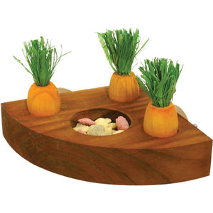 Wooden corner block with recess for animal food. Three wooden imitation carrots are also embedded in the wood.